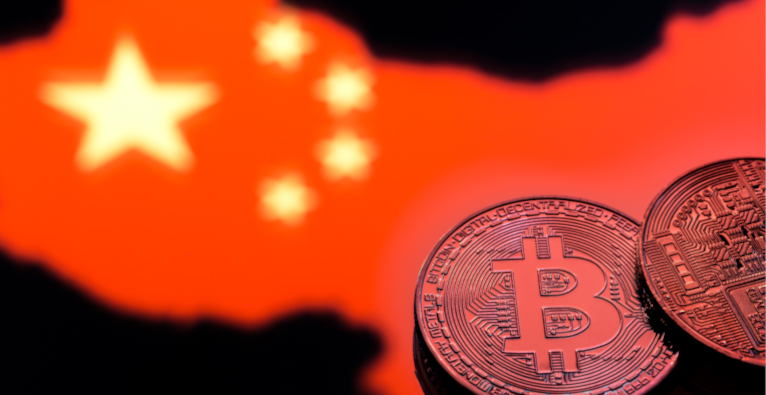 coins Bitcoin, against the background of the Chinese flag, concept of virtual money, close-up. Conceptual image of digital crypto currency.