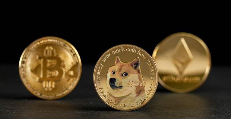 A picture of Bitcoin, Dogecoin and Ethereum coins
