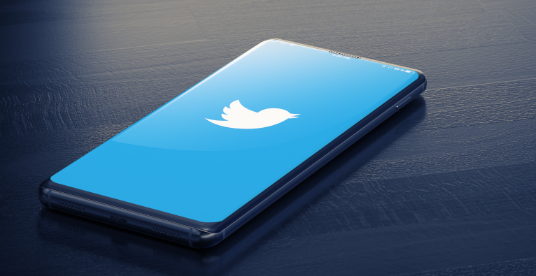 Twitter's logo on the screen of a smartphone
