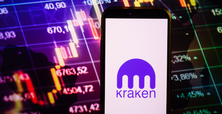 Smartphone displaying logo of Kraken cryptocurrency exchange on stock exchange diagram background